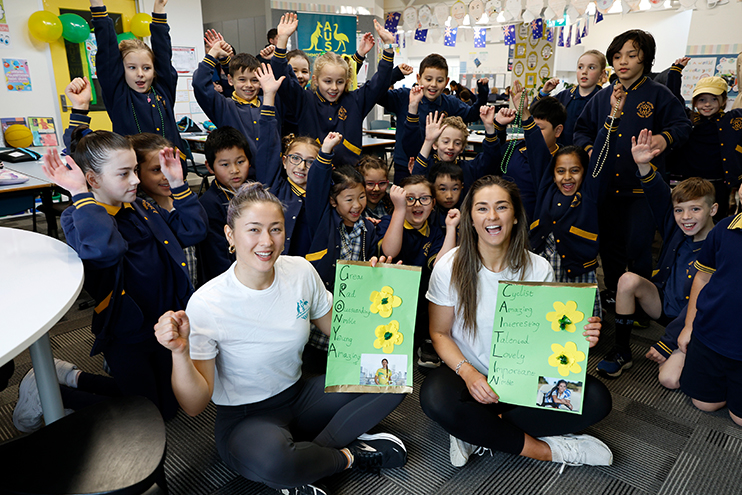 Badminton player Gronya Somerville and cyclist Caitlin Ward pose in a classroom full of children to help launch Borobi's Classroom education program.