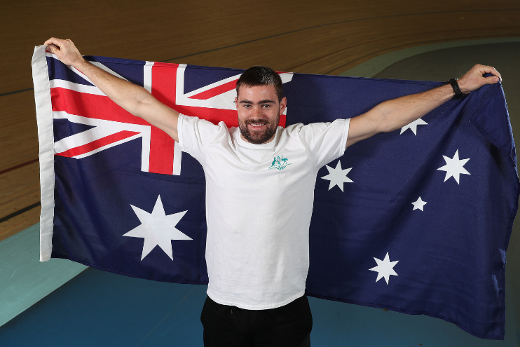 Beau Wottoon, cycling, holds an Australian Flag at the Birmingham 2022 Cycling Team Announcement