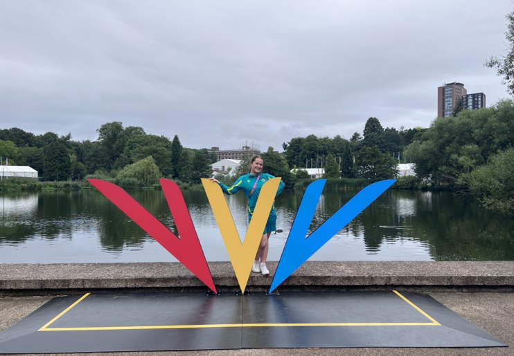 Maddie Barras poses at the Commonwealth Games Federation Logo at the Birmingham 2022 Commonwealth Games